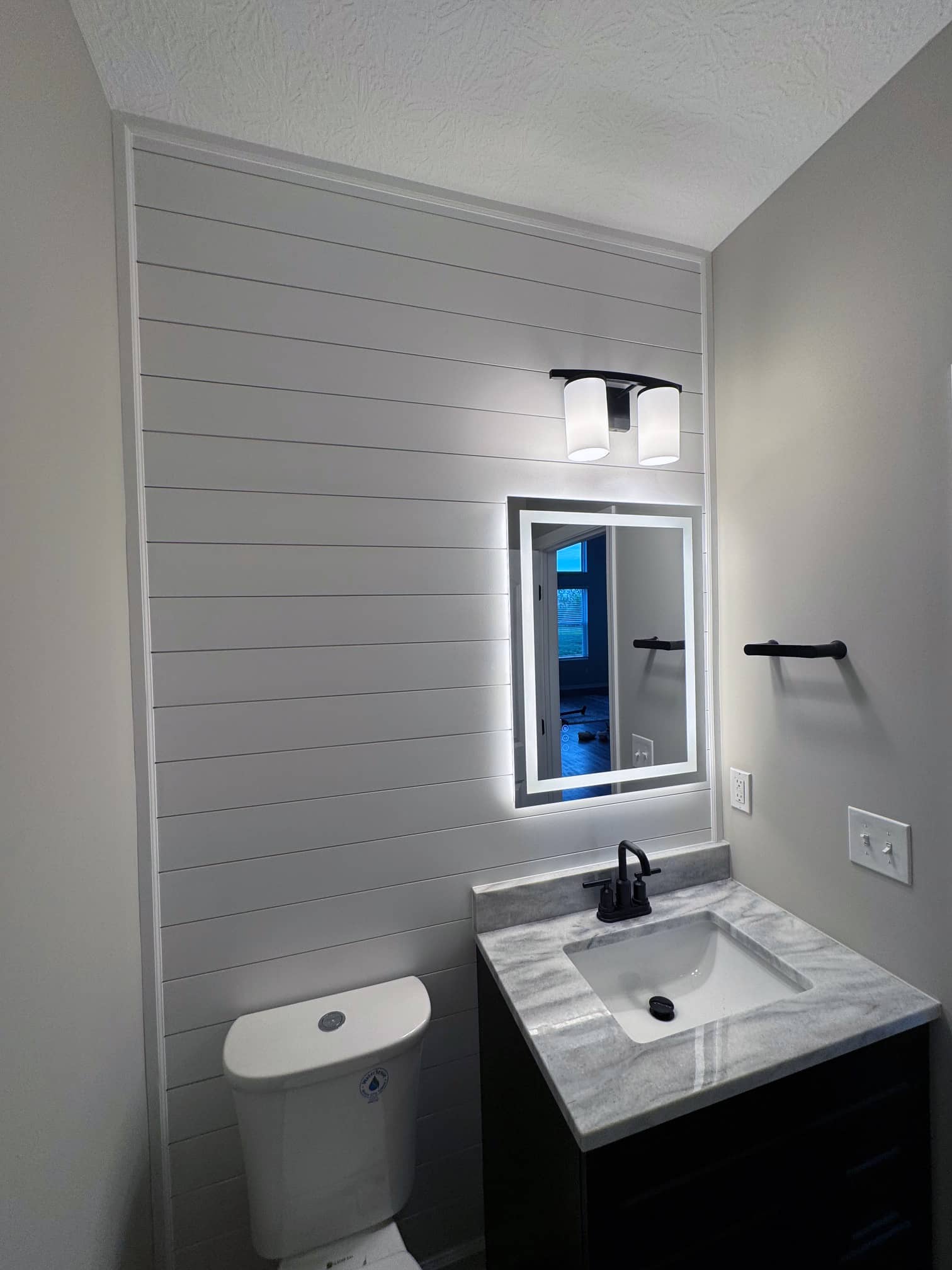 Small powder bathroom with modern vanity and toilet in a Gahanna, OH remodel